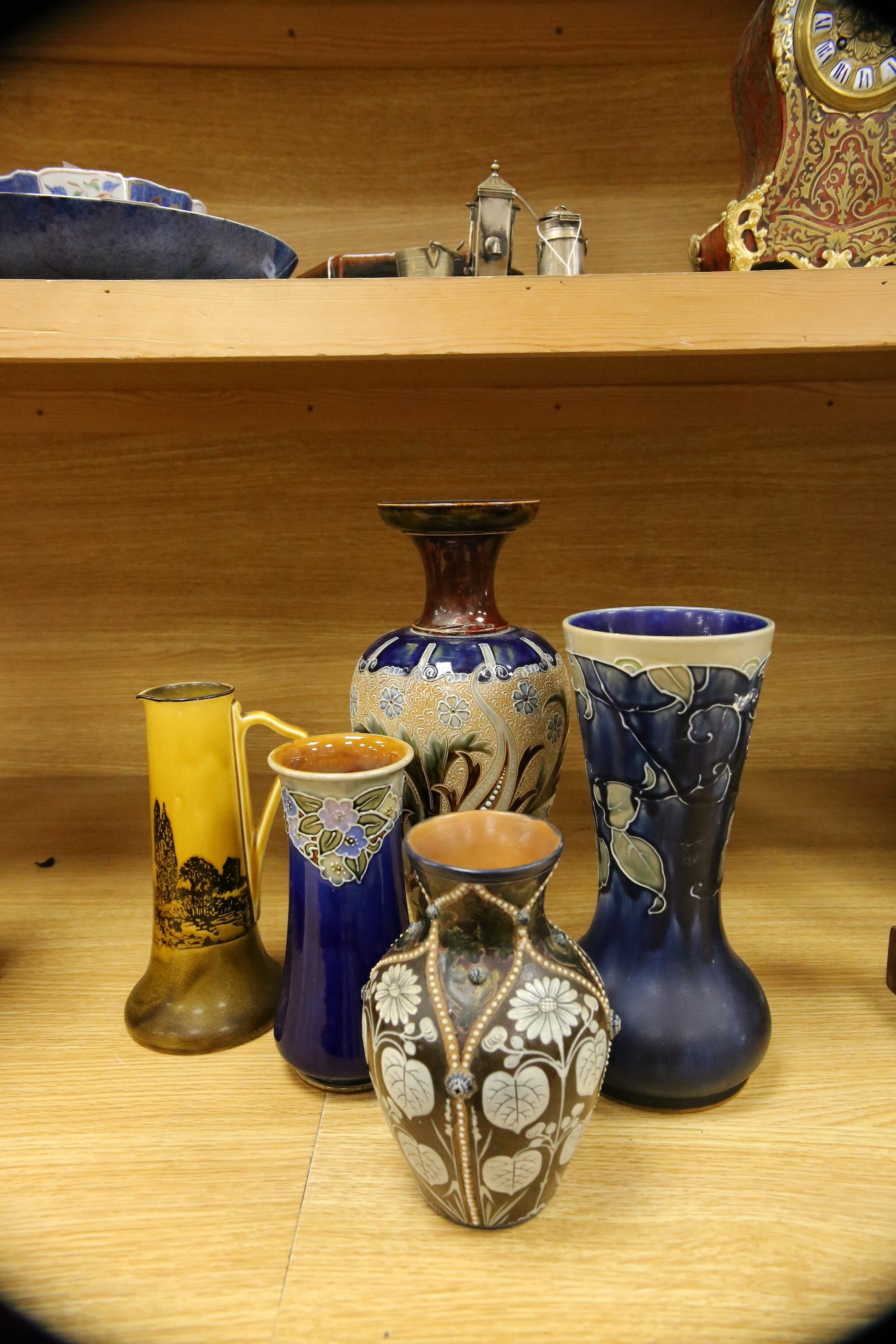 Four Royal Doulton vases and a yellow glazed jug items, tallest vase 34cm high. Condition - some crazing and faults, large vase has damage to lower neck